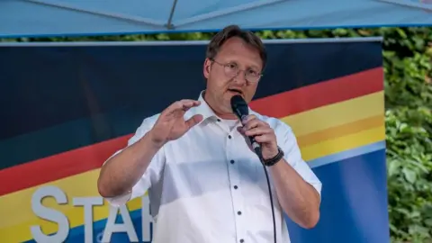 FERDINAND MERZBACH/NEWS5/AFP Robert Sesselmann of the far-right Alternative for Germany (AfD) party speaks at an election event in Sonneberg, eastern Germany on June 25, 2023