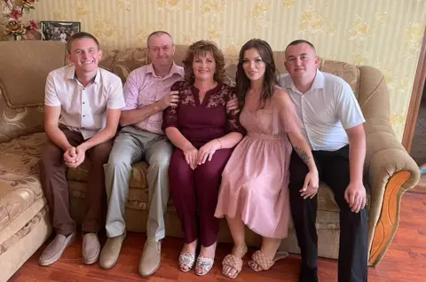 Simoroz family From left to right: Brother, Petro Simoroz, 21 years old. Father, Vasyl Simoroz. Mother, Natalya Simoroz. Wife, Olena Simoroz, 27 years old. Ivan Simoroz