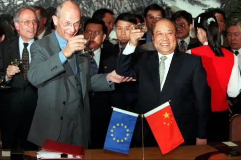 Getty Images Pascal Lamy, then director-general of the World Trade Organisation, signed the agreement of China's accession to the group in 2000.