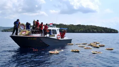 Reuters Flowers and petals with names of the crew members are dropped into the sea near Labuhan Lalang, Bali, Indonesia April 26, 2021