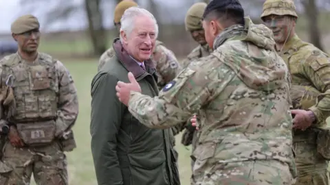 PA Media King Charles talking to soldiers