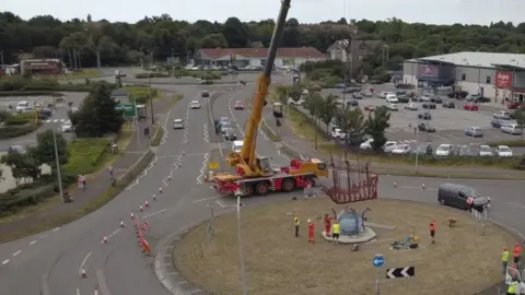 Tendring District Council The crane lowers the sculpture