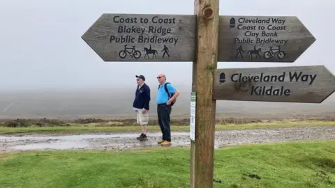 Travelling Blind Andrew Elliker-Reeve and volunteer on Cleveland Way