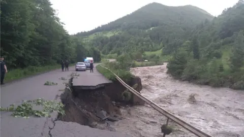 State Emergency Services of Ukraine A road destroyed by flooding in Ukraine