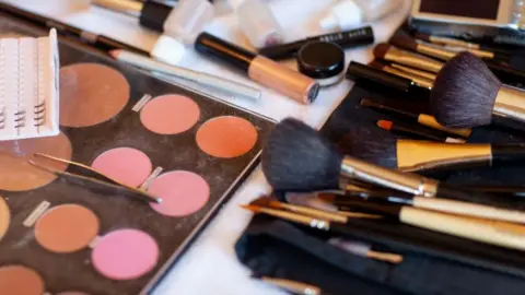 Getty Images Makeup palettes and brushes on table surface