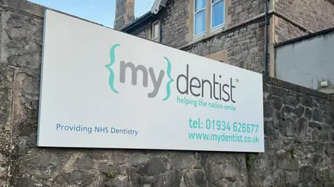 Sign for MyDentist with phone number below