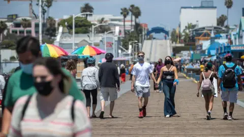 Getty Images People walk outside in Santa Monica