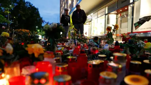 AFP People visit the makeshift memorial of candles and flowers for the victim of last weekend's fatal stabbing in Chemnitz, eastern Germany on August 30, 201
