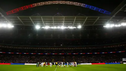 Getty Images Players observe a minute of silence to remember those who lost their lives in the recent Paris attack (Nov 2015)