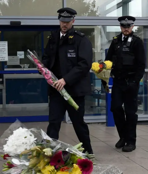 Getty Images police with flowers