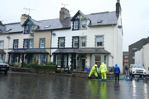 PA Media Flooded streets in Cockermouth