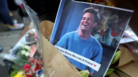 Reuters A makeshift memorial for actor Matthew Perry, the wise-cracking co-star of the 1990s hit television sitcom "Friends," who was found dead at his Los Angeles home October 28, is pictured on Bedford Street in Manhattan in New York City