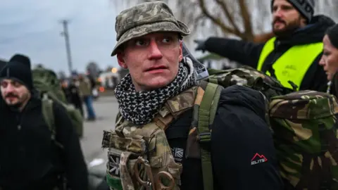 Getty Images Alex from the United Kingdom who served in Afghanistan as a paramedic arrives at the Polish-Ukrainian border crossing looking for transport to Lviv to join the fight against the Russian invasion - 6 March 2022