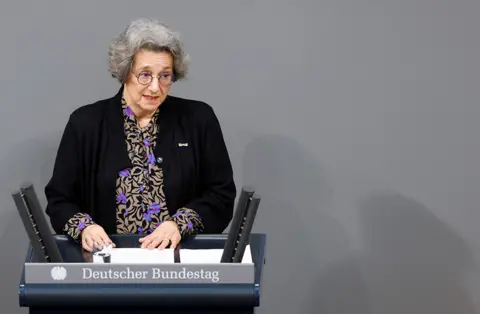 Michelle Tantussi / Reuters Rozette Kats, 80-year-old Holocaust survivor whose parents were murdered in the Auschwitz Nazi concentration camp, speaks during a memorial ceremony commemorating the victims of the Holocaust on the International Holocaust Remembrance Day, at the lower house of the parliament or Bundestag, in Berlin, Germany, on 27 January 2023