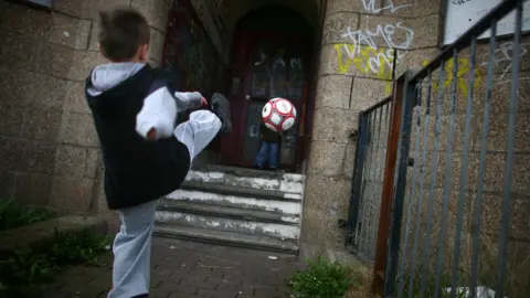 Getty Images A boy kicking a football