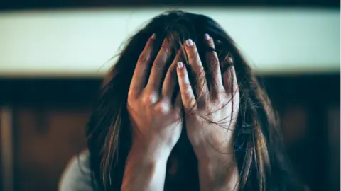 Getty Images Woman in despair