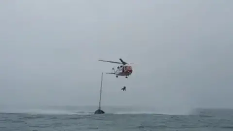 RNLI the helicopter rescues the unwell crew member