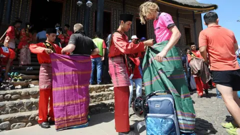 Getty Images Tourists are given sarongs in Indonesia (file image)