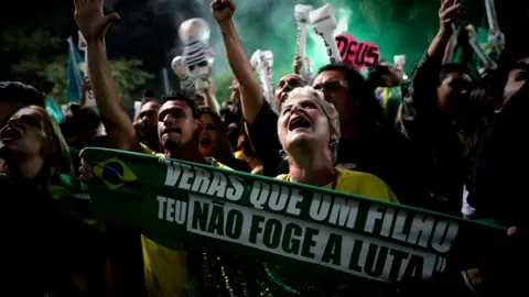 EPA Supporters of Brazilian far-right presidential candidate Jair Bolsonaro celebrate his victory at the Paulista Avenue, in Sao Paulo, Brazil, 28 October 2018.