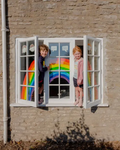 Tom Skipp Toby and Lara at the window