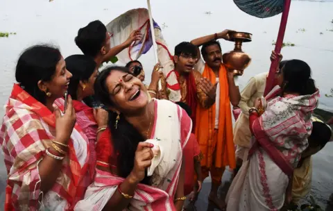DIBYANGSHU SARKAR/ Getty Images Devotees celebrate.