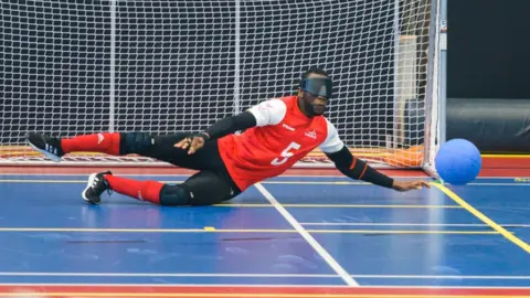 Goalball UK Caleb Nanevie diving to save the ball