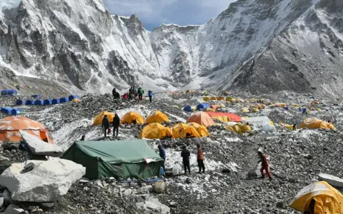 Getty Images Trekkers and porters gather at Everest Base Camp on 25 April 2018.