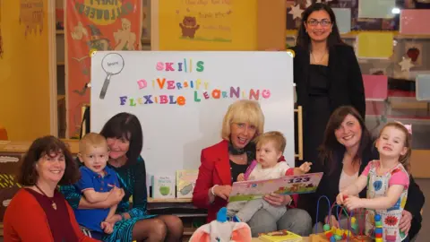 SDS Older staff with children in a nursery