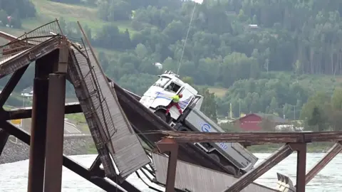 A truck stuck on a raised part of the collapsed bridge