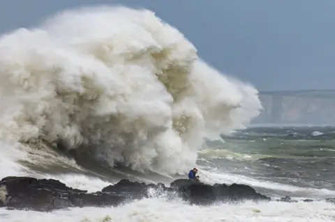 Matthew Horwood / Getty Images Waves crash against the harbour wall on 10 August 2019 in Porthcawl, Wales.