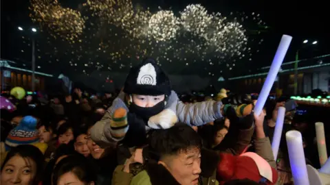 AFP/Getty Revellers watch as a fireworks display marks the arrival of the new year following a countdown event on Kim Il Sung Square in Pyongyang on January 1, 2019