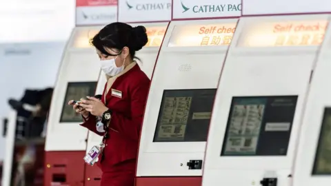 AFP/Getty Cathay Pacific cabin crew with mask