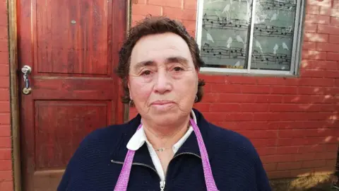 BBC Sara Jineo, a mother whose baby was taken without her permission, outside her home in Temuco, Chile