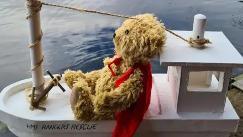 Jane Burgoyne Teddy on wooden boat