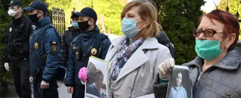 Getty Images Relatives of the Ukrainian armed forces servicemen, held in prisons of Russia-backed separatists in the east of the country, hold their portraits on 24 April