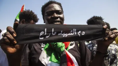 Getty Images An anti-government protester calling for full civilan rule in Khartoum, Sudan - 30 September 2021