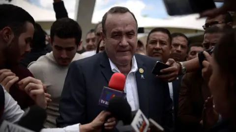 Getty Images Mr Giammattei speaking to press following his election on 11 August