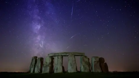 Josh Dury Stonehenge under a purple night sky