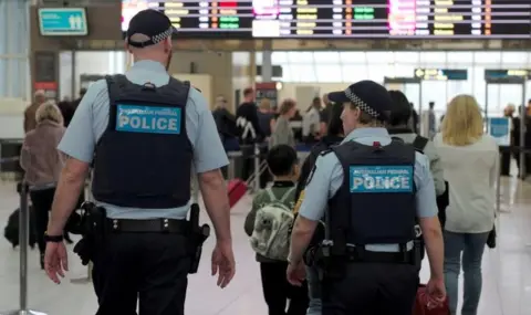 Reuters Two Australian Federal Police officers walk through Sydney Airport