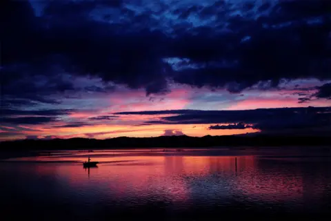 Kim Kyung-Hoon / Reuters A person fishes on a boat on Lake Hamana in Hamamatsu, Shizuoka Prefecture, Japan