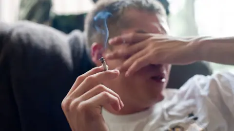 Getty Images Young man smokes cannabis