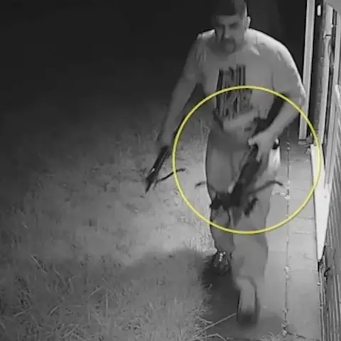 West Midlands Police Saghawat Ramzan holding a crossbow at the scene of the murder of Waseem Ramzan and Khuzaimah Douglas