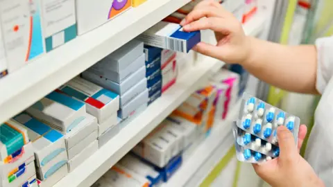 Getty Images Shelves of drugs in a pharmacy