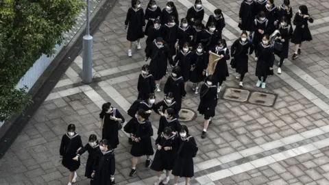 Getty Images Schoolgirls are pictured after school in Tokyo on 4 November 2021