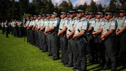 Getty Images Members of the new National Guard take part in a ceremony on 30 June