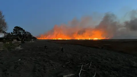 BBC/Jon Ironmonger The fire started out small before the flames spread across the marshland, said an eyewitness