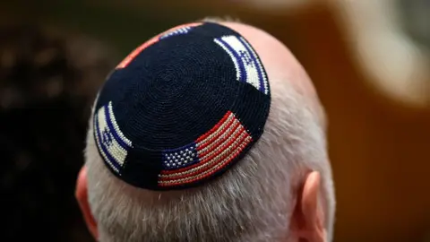 EPA An attendee wears a kippah decorated with Israel's and US flags during a solidarity vigil for Israel held at the Stephen Wise Temple in Los Angeles, California, USA, 08 October 2023