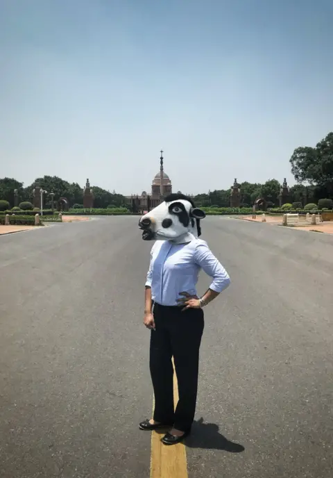 Sujatro Ghosh A woman with a cow mask in front of the presidential palace