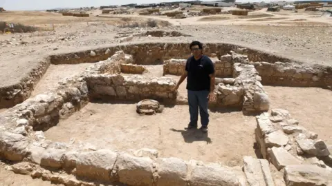 Getty Images A worker from Israel's Antiquities Authority at the site of an ancient mosque