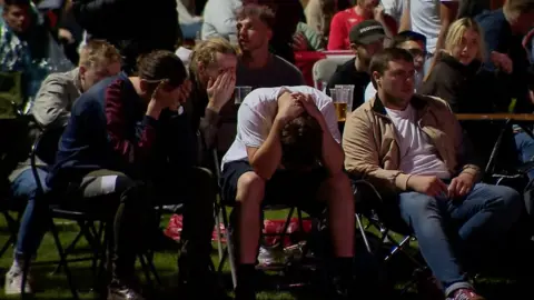 Fans with heads in their hands